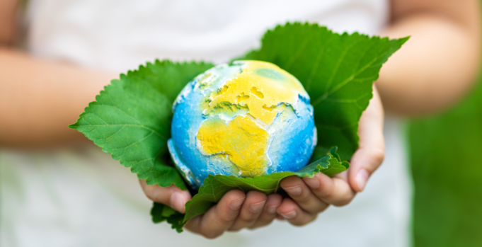 Greenwashing Exposed: Maintain Integrity in Sustainable Marketing An image of a person holding a globe, representing sustainability over greenwashing.