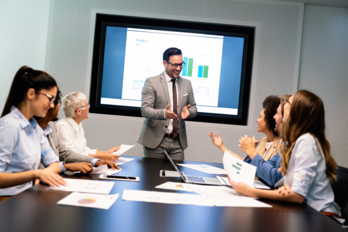 Harmonizing Marketing and Sales: A Path to Revenue Growth A team leader presenting revenue growth after proper alignment of marketing and sales.