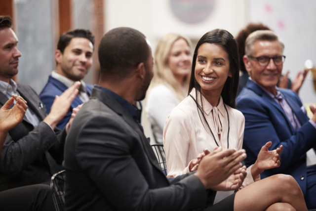 Professional innovators participating and networking at a marketing event.