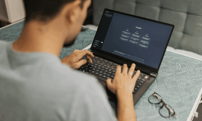 How Marketers Should Read the Latest ChatGPT Usage Report A person uses ChatGPT on a laptop.