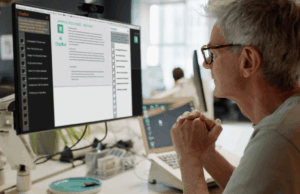 The AI Divide: How Marketers Really Feel About Automation A marketer sits at a desk reviewing AI-generated content on a computer screen in a modern office, reflecting the growing role of artificial intelligence in marketing workflows.