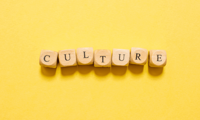 Letter blocks spelling out the word "culture" sit against a yellow background, emphasizing the cultural power of brands as the central theme of the piece.