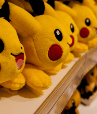 30 Years of Pokémon: Branding Lessons From a Pop Culture Phenomenon Multiple Pikachu plush toys displayed on store shelves, showcasing Pokémon’s global merchandising and brand longevity.