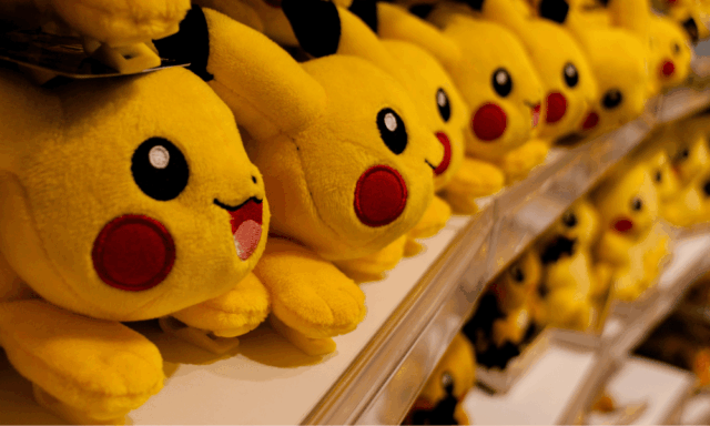 Multiple Pikachu plush toys displayed on store shelves, showcasing Pokémon’s global merchandising and brand longevity.