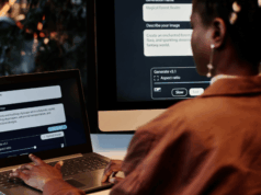 Should Marketers Disclose AI Use? A New Framework Weighs In Person using an AI image generation tool on a laptop and desktop computer to create digital visuals for advertising.