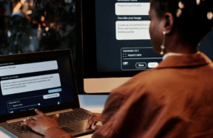 Should Marketers Disclose AI Use? A New Framework Weighs In Person using an AI image generation tool on a laptop and desktop computer to create digital visuals for advertising.